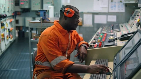 African marine engineer officer in engine control room ECR. Stock Footage 108950730