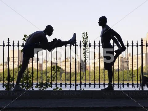 African men stretching on railing Stock Photos