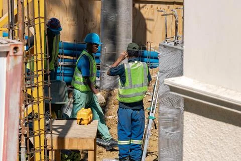 African men working outside on a construction site. Builders Stock Photos