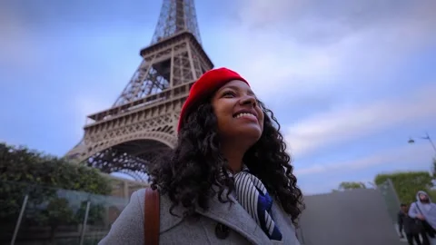 African millennial walking by Eiffel Tower in Paris Video stock 348088439