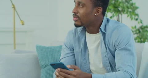 African mixed race guy user holding smart phone look at cellphone using mobile Stock Footage 151600872