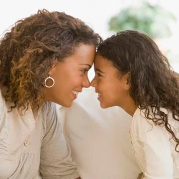 African mother and daughter touching noses Stock Photos