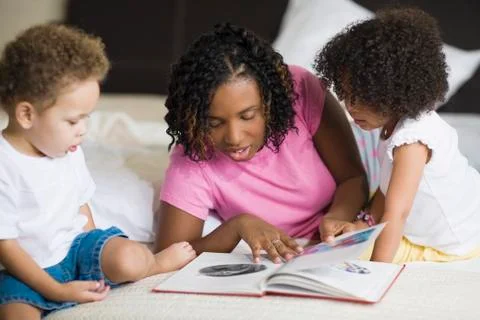 African mother reading to children Stock Photos