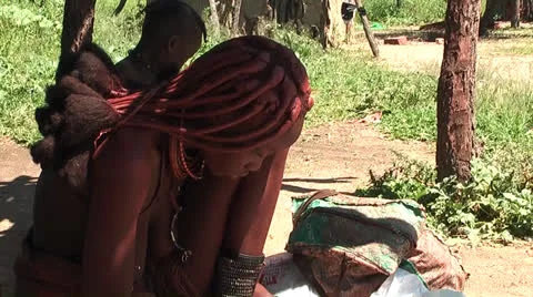 African native tribes - Young Himba girl producing jewelery in Namibia Видео 26932860