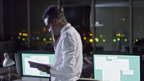 African Office Worker Talking on Phone and Reading in Notepad Stock Footage