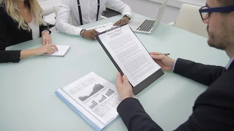 African partners agree to work on contract in office at meeting with businessman Video stock 85375330