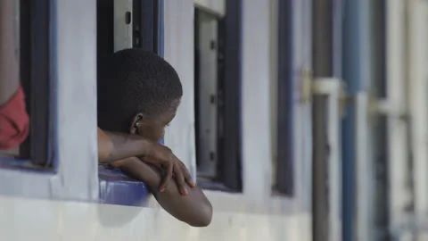 African passenger sitting at the train window at the train station. Tanzania Stock Footage 132286725