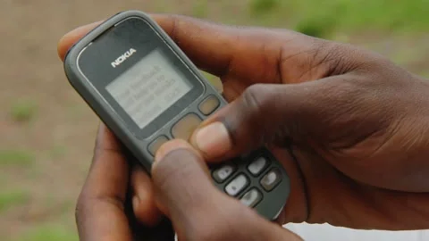 African person using old Nokia phone Stock Footage