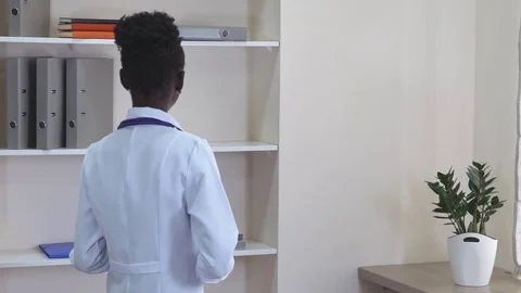African physician turns to the camera and smiling Stock Footage 75617006