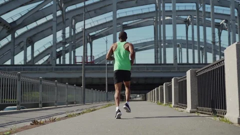 African runner jogging down urban bridge Video stock 117065515