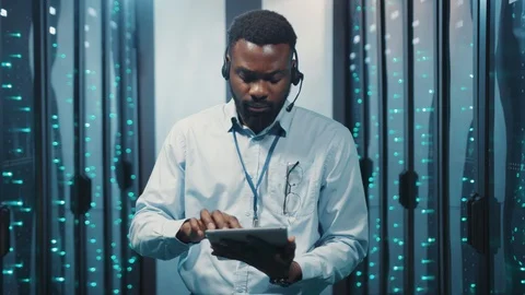 African server technician working on tablet in high tech data center. Portrait Stock Footage 119081713