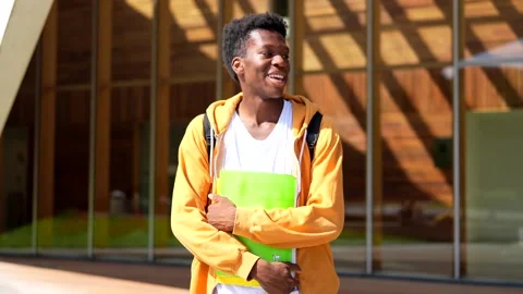 African smiling student standing outside the university Stock Footage 282958383