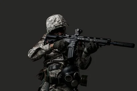 African soldier aiming rifle isolated on dark background Фото