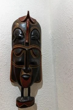 An African souvenir with unique patterns hangs on the wall, adding ethnic cha Stock Photos