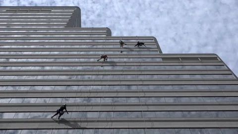 African stock video of window washers working at height on skyscraper buildin Stock Footage 85895987