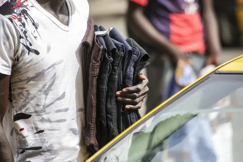African street pants vendor between cars Stock Photos