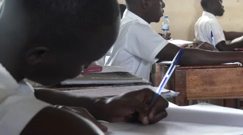 African student writing in notebook at school-homework handwriting-Edu Africa Stock Footage 58989361