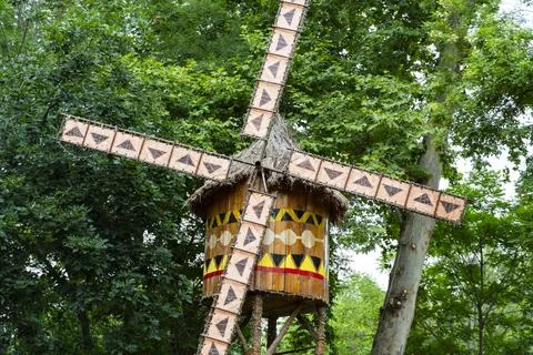 African Style Decorative Windmill in Theme Park Surrounded by Green Trees 写真素材