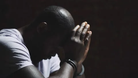 African suspect man with handcuffs in interrogation room after being caught 스톡 동영상 142807258