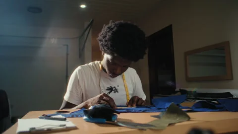 An african tailor making clothes Stockbeeldmateriaal 243686669