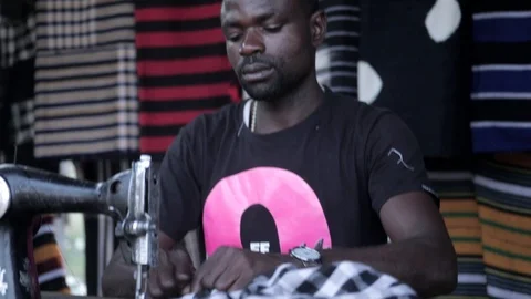 An African tailor using an old sewing machine Stock Footage 105376948
