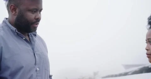 African tech in gloves holding panel uncoiling cable showing plug on roof for Stock Footage 337287969