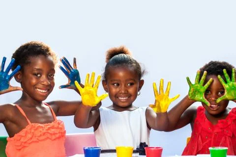 African threesome showing painted hands. Stock Photos