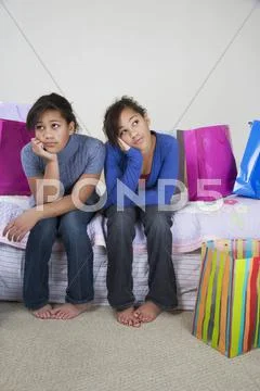 African twin sisters looking bored Stock Photos
