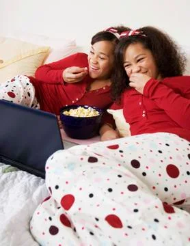 African twin sisters watching movie Stock Photos