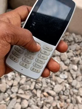 African using ash keypad mobile phone. Stock Photos