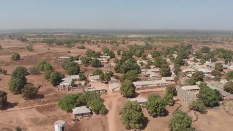African village with brick buildings on plains. Gambia. Drone Stock Footage