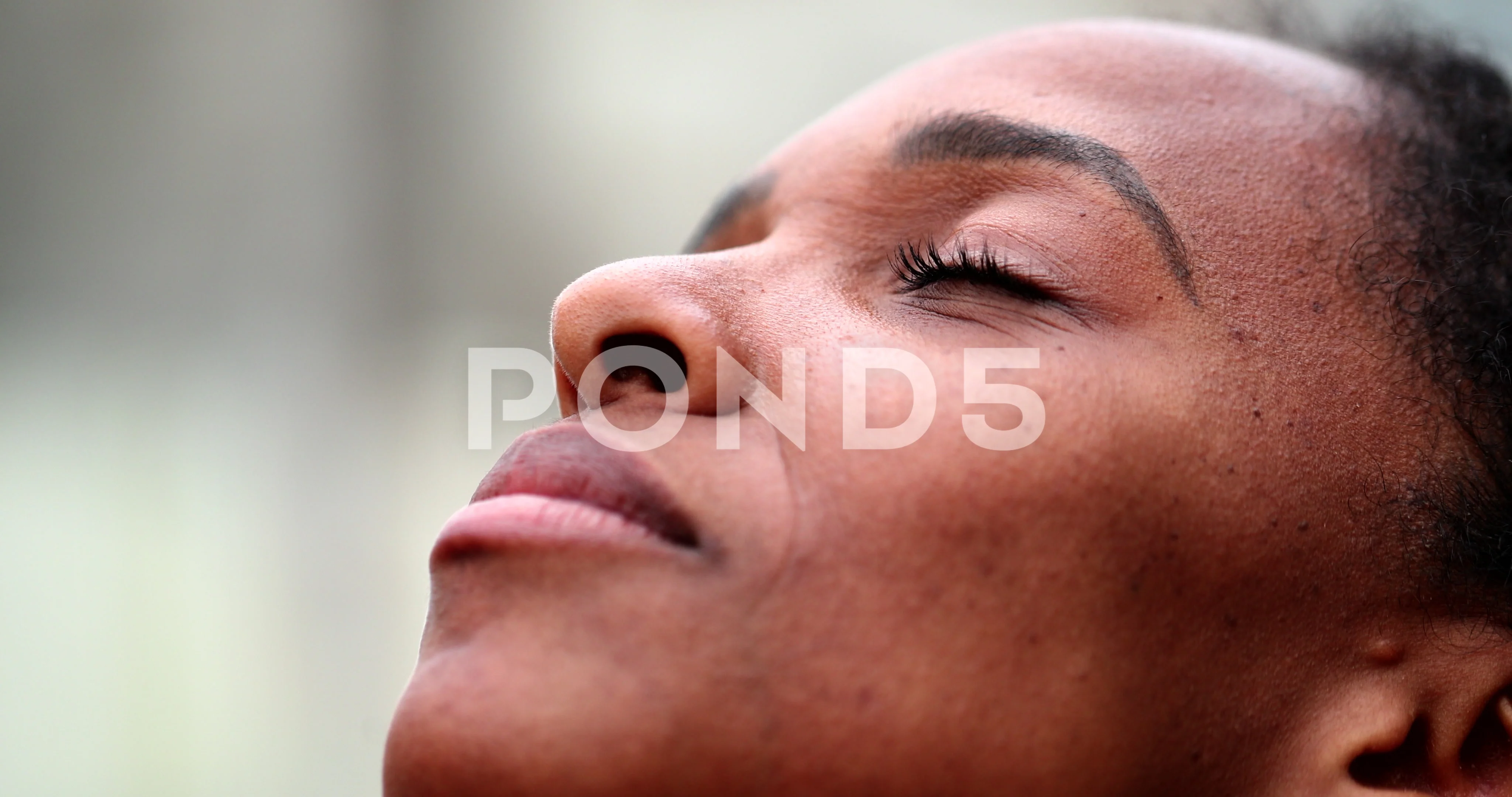 African woman closing eyes in meditation Stock Video Pond5