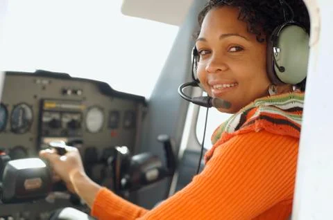 African woman in cockpit of airplane Stock Photos