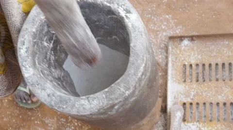 African woman grinds the flour in the mortar slow motion Stock Footage