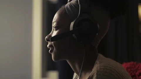 African woman play game using joystick sitting at dark living room.Close-up of Stock Footage 236334773