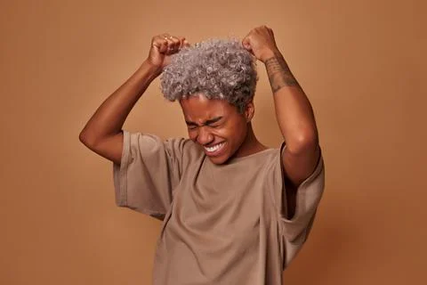 African woman rejoices praises or winning competition, makes fist pump Stock Photos