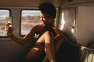 African Woman Taking A Selfie With Mobile Phone In Camper Van Stock Photos