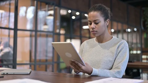 African Woman using Digital Tablet at Work Stock Footage 123836631