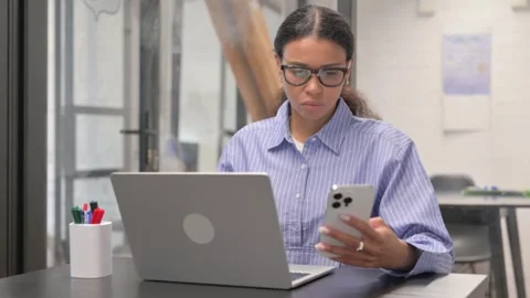 African Woman Using Multiple Devices for Work Stock Footage 306706679