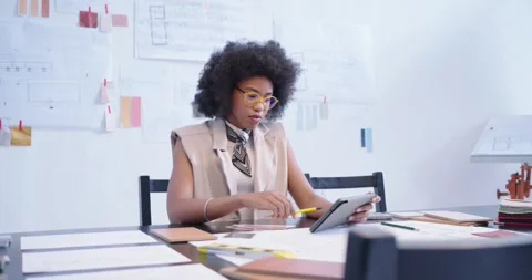 African woman using tablet drawing plan with yellow pencil aligning swatch Stock Footage 339272672