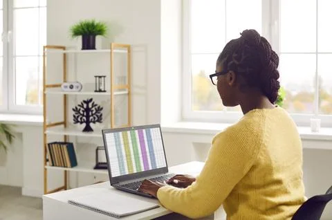 African woman working with spreadsheets computer in office Stock Photos