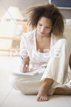 African Woman Writing On Note Pad