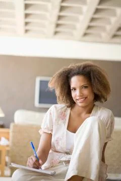 African woman writing on note pad Stock Photos