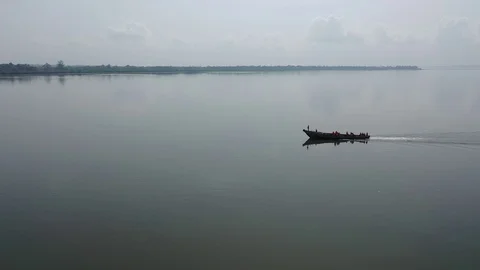 African Wooden Boat Slowly moving on Calm River Stock Footage