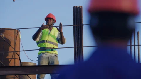 African worker directing crane at construction site,Tanzania  Africa Stock Footage 132128811