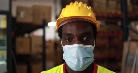 African worker man inside warehouse wearing protective mask Stock Footage 145434553