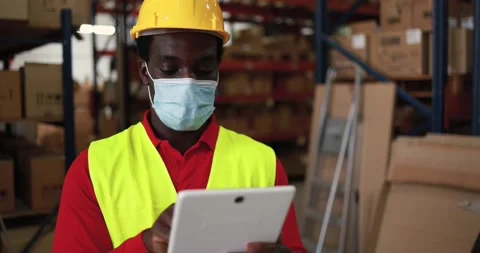 African worker man using tablet inside warehouse Stock Footage 145434531