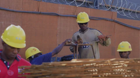 African worker operating electric welding at construction site， Africa Stock Footage 132332459