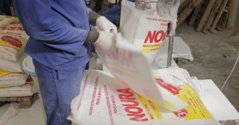 African Worker Packs Up Products In Plastic Bags (4K) Stock Footage 60937963
