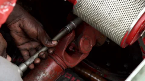 An African worker screwing a bolt. Video stock 67444371